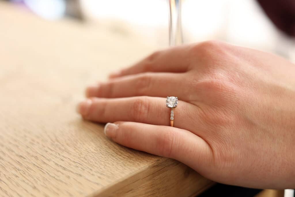 Round cut diamond in a side stone ring