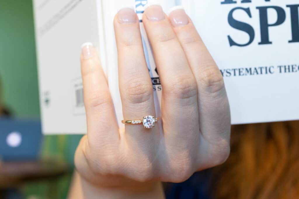 1ct round cut diamond in a yellow gold petite side-stone setting