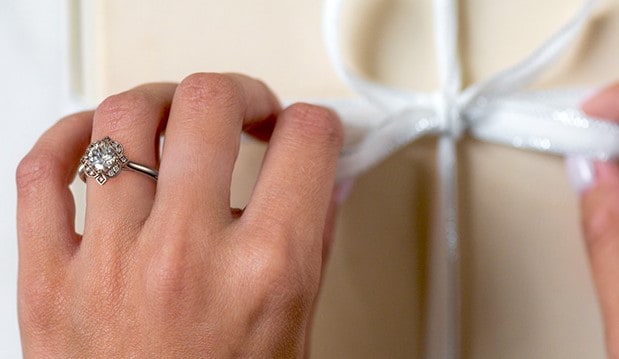 Art Deco Floral Halo Engagement Ring on a hand