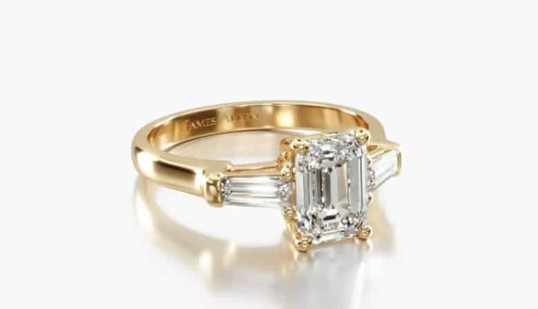 Tapered Baguette setting in yellow gold with emerald diamond in the center