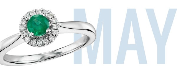 May's birthstone emerald set in a beautiful ring with 'May' in the backdrop