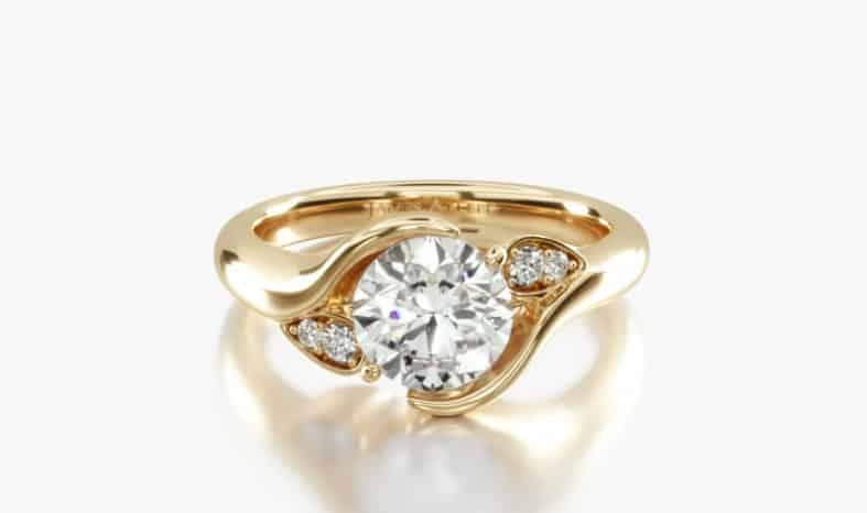 close-up of a yellow gold leaf designed bypass tension ring