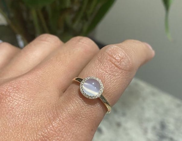 Cabochon Moonstone shown on a finger
