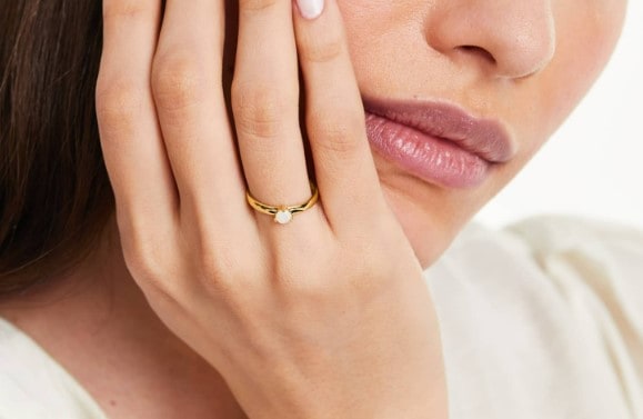 Yellow gold solitaire opal engagement ring