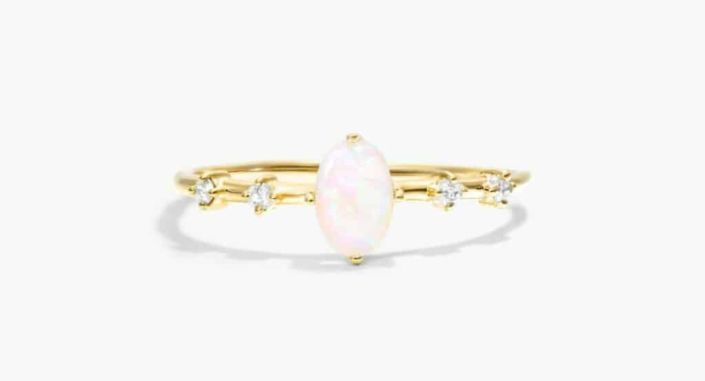 Romantic oval opal enagegemnt ring with diamond accents