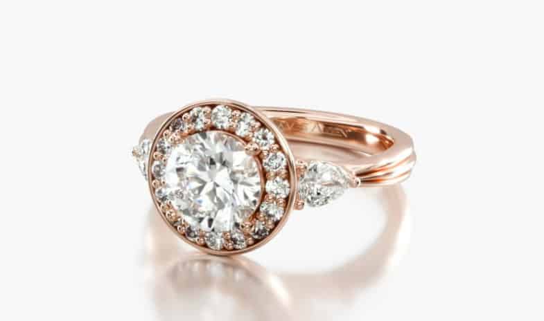 halo with pear shape side stones and carved band